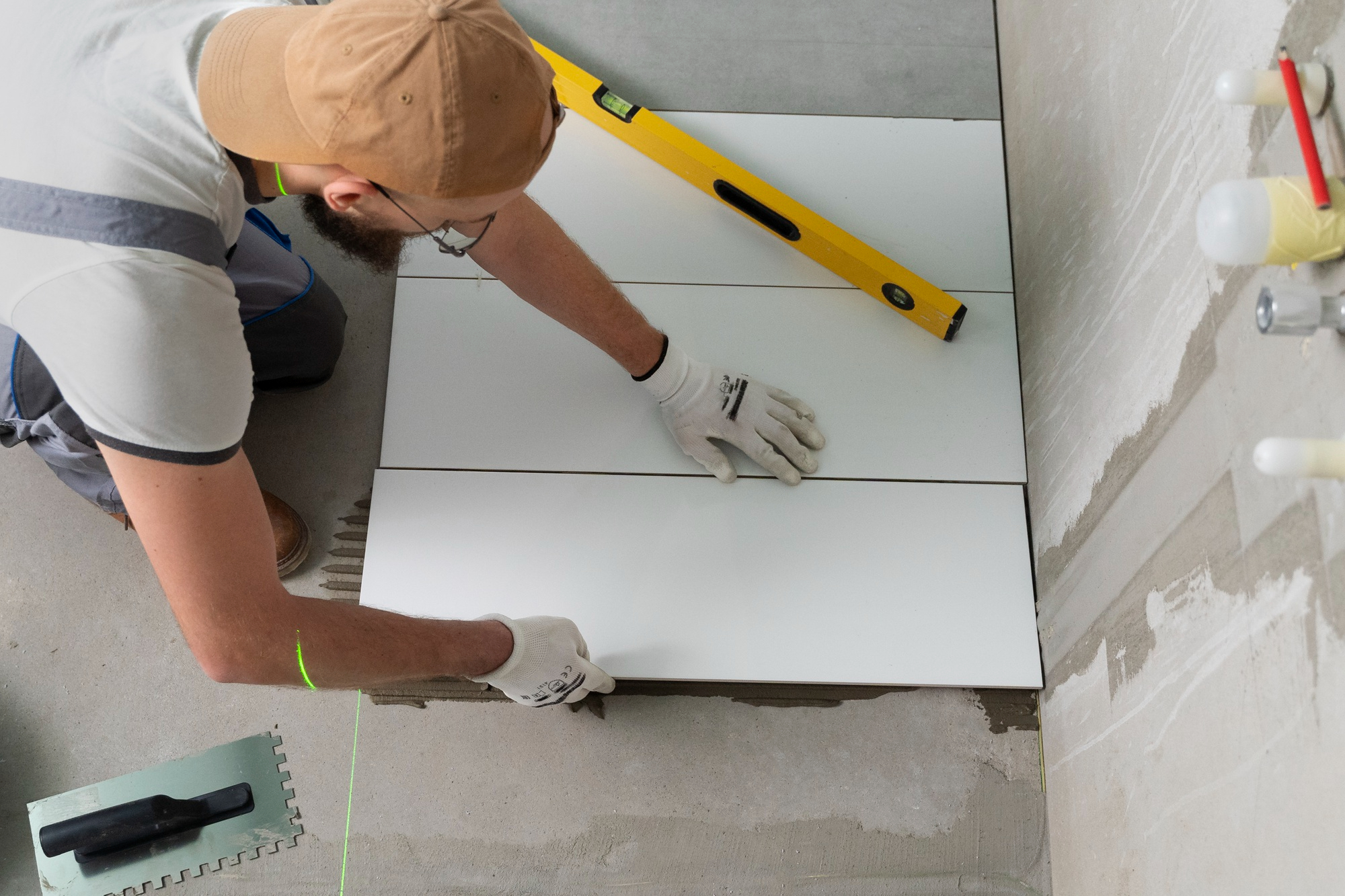 man working with a bathroom renovation plumber in simpsonville